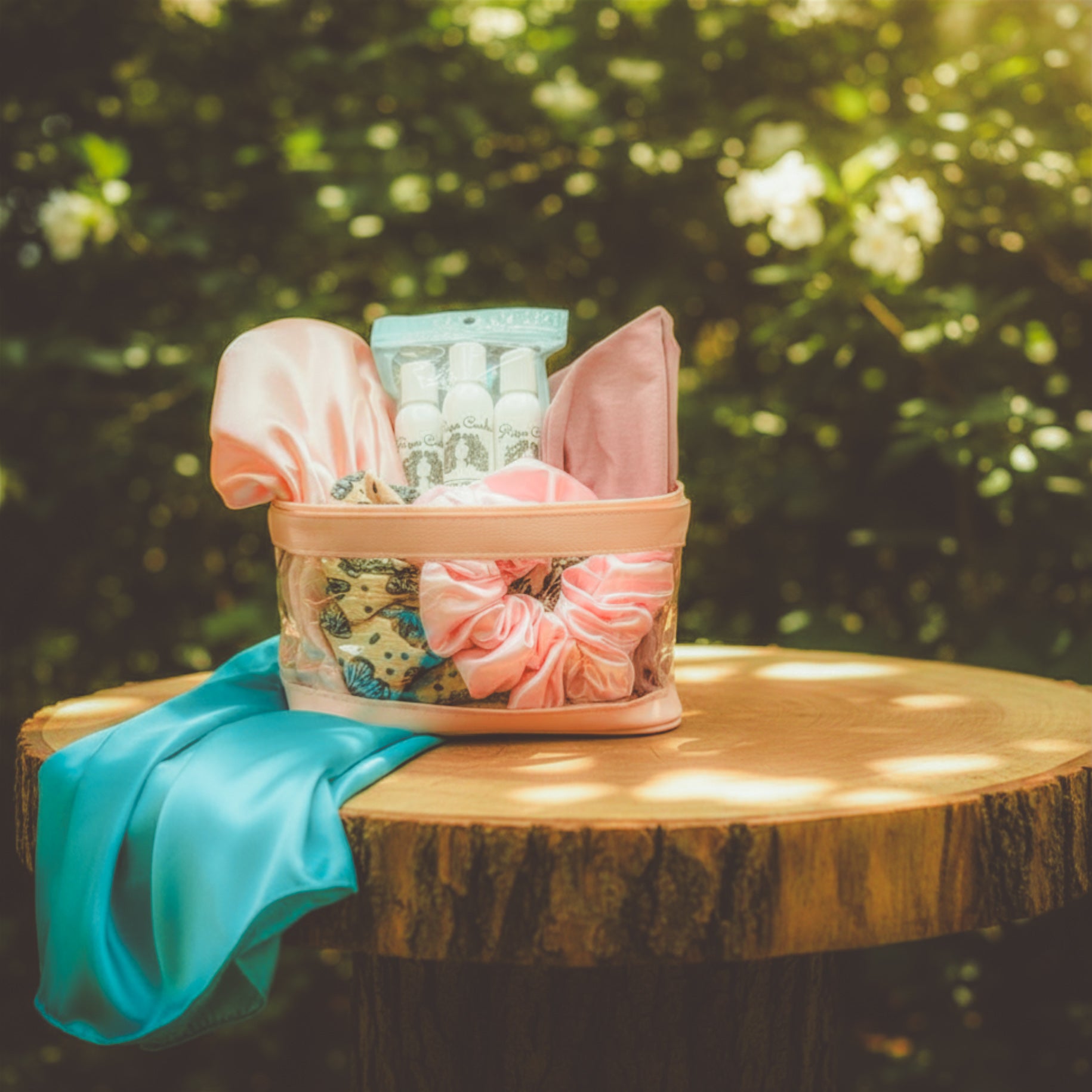 Clear basket with pink and blue items on a wooden surface outdoors